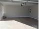 View of an empty, clean garage with automatic door and concrete floor at 4166 Saltwood Dr, Hickory, NC 28602