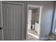 Hallway leading into bathroom featuring a vanity and vinyl flooring at 4166 Saltwood Dr, Hickory, NC 28602