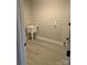 Laundry room with a utility sink, vinyl flooring, and white paint at 4166 Saltwood Dr, Hickory, NC 28602