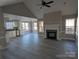 Spacious living room features a modern fireplace, large windows, and seamless flow to the kitchen and dining area at 4166 Saltwood Dr, Hickory, NC 28602