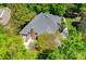 Aerial view of home with lush trees and a brick chimney, surrounded by abundant green foliage at 4340 Sequoia Red Ln, Charlotte, NC 28226