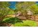 Well-maintained backyard with lush green lawn, mature trees and a classic wooden fence at 4340 Sequoia Red Ln, Charlotte, NC 28226