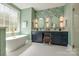 Elegant bathroom featuring double vanity, soaking tub under a large window, and stylish wallpaper at 4340 Sequoia Red Ln, Charlotte, NC 28226