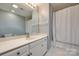 Well-lit bathroom with a white vanity, a large mirror, and a shower and bathtub combo at 4340 Sequoia Red Ln, Charlotte, NC 28226