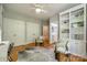 Cozy bedroom with hardwood floors, built in shelving, and ensuite bathroom at 4340 Sequoia Red Ln, Charlotte, NC 28226