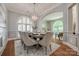 Formal dining room with large windows, designer lighting and seating for eight at 4340 Sequoia Red Ln, Charlotte, NC 28226