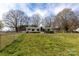 Backyard featuring fenced in property, green grass, and trees at 5212 Old Concord Rd, Salisbury, NC 28146