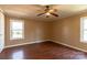 Bedroom featuring hardwood floors, ceiling fan, and multiple windows at 5212 Old Concord Rd, Salisbury, NC 28146