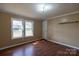 Bedroom featuring hardwood floors and two windows at 5212 Old Concord Rd, Salisbury, NC 28146