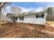 Ranch-style home featuring white horizontal siding, green metal roof, covered front porch, and minimal landscaping at 5212 Old Concord Rd, Salisbury, NC 28146
