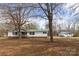 Cozy single-story home with a green metal roof, a detached garage, and a spacious front yard at 5212 Old Concord Rd, Salisbury, NC 28146