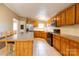Bright kitchen featuring oak cabinetry, a central island, and tile flooring at 5212 Old Concord Rd, Salisbury, NC 28146