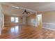 Bright living room featuring wood floors, ceiling fan, and large window at 5212 Old Concord Rd, Salisbury, NC 28146
