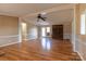 Spacious living room with wood floors, ceiling fan, and brick fireplace at 5212 Old Concord Rd, Salisbury, NC 28146