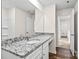 Bathroom with a granite countertop, white cabinetry, and visible shower/tub combo at 642 Lamorak Pl, Richburg, SC 29729