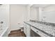 Well-lit bathroom featuring granite counters, white cabinets, and a shower-tub combination at 642 Lamorak Pl, Richburg, SC 29729