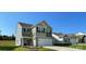 Two-story home featuring gray and tan siding, black shutters, and an attached two-car garage at 642 Lamorak Pl, Richburg, SC 29729