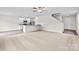 Spacious living room with a staircase, neutral carpet, and an adjacent kitchen with modern appliances at 642 Lamorak Pl, Richburg, SC 29729