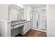 Modern bathroom featuring a large mirror, vanity with granite counters, and glass shower at 668 Lamorak Pl, Richburg, SC 29729