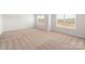 Bright bedroom with neutral walls, carpeted floors, and large windows at 668 Lamorak Pl, Richburg, SC 29729