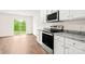 Bright kitchen featuring white cabinets, granite countertops, and stainless steel appliances at 668 Lamorak Pl, Richburg, SC 29729