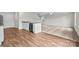 Open-concept living room featuring wood floors, granite countertops, and stainless steel appliances at 668 Lamorak Pl, Richburg, SC 29729