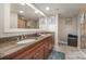 Bathroom showcasing a double vanity with granite counters and wood cabinetry, with neutral walls at 701 Royal Ct # 102, Charlotte, NC 28202