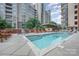 Resort-style community pool area with lounge chairs, fireplace, and meticulous landscaping at 701 Royal Ct # 102, Charlotte, NC 28202