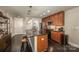 Features a kitchen island with seating, dark hardwood floors, and stainless steel appliances at 701 Royal Ct # 102, Charlotte, NC 28202