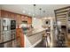 Modern kitchen features stainless steel appliances, granite counters, and sleek dark hardwood flooring at 701 Royal Ct # 102, Charlotte, NC 28202