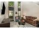 Bright living room features tall windows, hardwood floors, and comfortable seating at 701 Royal Ct # 102, Charlotte, NC 28202
