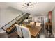 View of the open floor plan with dark wood floors, kitchen, dining room and the unique staircase at 701 Royal Ct # 102, Charlotte, NC 28202