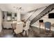 Bright living room showcasing the open floor plan with dark wood floors and a modern light fixture at 701 Royal Ct # 102, Charlotte, NC 28202