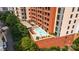 Stunning aerial view of rooftop pool with lounge chairs and brick condo building at 701 Royal Ct # 102, Charlotte, NC 28202