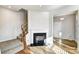 Open-concept living room features a fireplace and hardwood floors at 8005 Downy Oak Ln, Charlotte, NC 28269