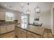 Bright eat-in kitchen with a large island, modern appliances, granite countertops, and stylish pendant lighting at 8009 Downy Oak Ln, Charlotte, NC 28269
