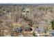 High-angle view of residential houses nestled amongst dense trees, emphasizing a quiet and secluded community setting at 8123 Chrisbry Ln, Charlotte, NC 28215