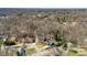 Scenic aerial view of a neighborhood nestled among trees, highlighting a peaceful residential setting with a distant city skyline at 8123 Chrisbry Ln, Charlotte, NC 28215