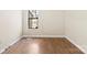A bedroom with wood floors, a large window and neutral wall color at 8123 Chrisbry Ln, Charlotte, NC 28215