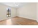 This spacious bedroom boasts wood floors and a bright window at 8123 Chrisbry Ln, Charlotte, NC 28215