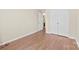 Simple bedroom with wood floors, neutral paint, and a double door closet for storage at 8123 Chrisbry Ln, Charlotte, NC 28215