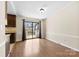 Open concept dining room featuring laminate wood floors and sliding glass doors to the outside deck at 8123 Chrisbry Ln, Charlotte, NC 28215