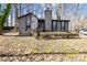 Charming exterior featuring a stone accent wall, chimney and well-maintained landscaping at 8123 Chrisbry Ln, Charlotte, NC 28215