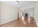 Expansive living room boasting laminate wood floors, open layout, and seamless flow between spaces at 8123 Chrisbry Ln, Charlotte, NC 28215