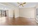 Bright living room featuring laminate wood floors, ceiling fan, and sliding glass door to the outside at 8123 Chrisbry Ln, Charlotte, NC 28215