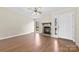 Inviting living room featuring laminate wood floors, a stone fireplace, and white front door at 8123 Chrisbry Ln, Charlotte, NC 28215