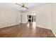 Open floor plan featuring laminate wood floors, ceiling fan, and dining room in background at 8123 Chrisbry Ln, Charlotte, NC 28215