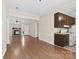 Spacious living room featuring laminate wood floors, an open floor plan, and a stone fireplace at 8123 Chrisbry Ln, Charlotte, NC 28215