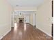 Open-concept living space showcasing laminate wood floors, an airy layout, and a stone fireplace at 8123 Chrisbry Ln, Charlotte, NC 28215
