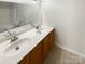 Bright bathroom with double sink vanity and large mirror at 8813 Gerren Ct, Charlotte, NC 28217